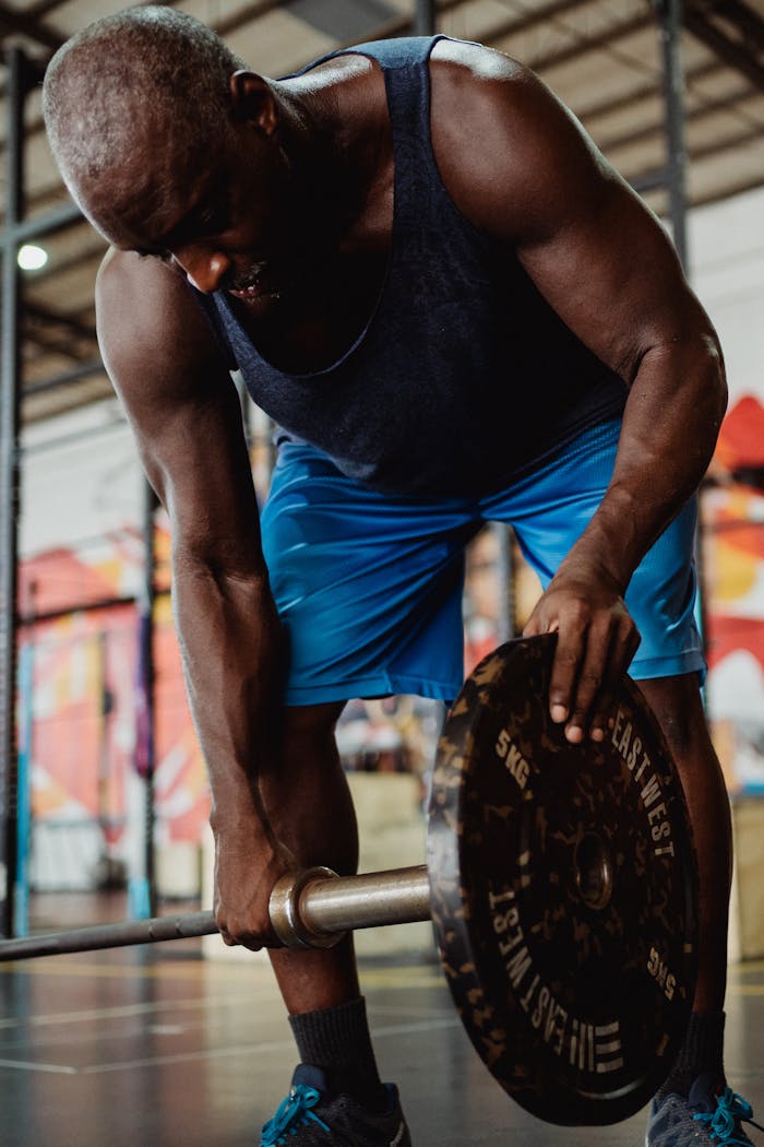 Strong athlete gearing up for a weightlifting session in a vibrant gym setting.